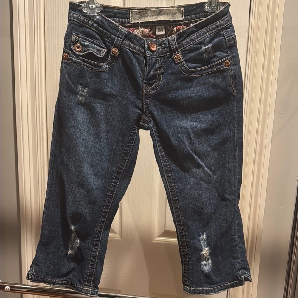 Seven cropped flare Blue Jeans size 24. Flap back buttons. Destroyed denim look.
